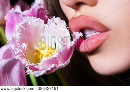 Sexy Sensual Young Woman Lips With Tulips Flowers Bouquet. Blowjob And Kiss, Sensual Tongue Licks A 