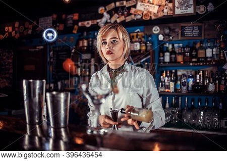 Girl Barman Formulates A Cocktail On The Taproom
