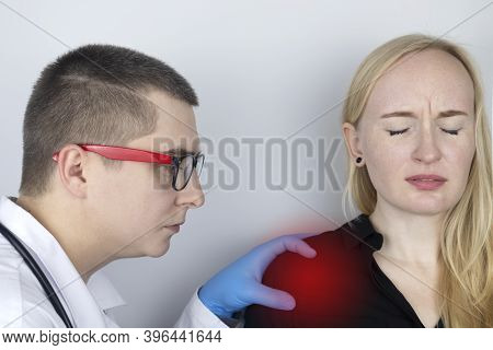 A Woman Suffers From Shoulder Pain. Shoulder Injury, Tendonitis, Sprain, Or Tendon Inflammation. The