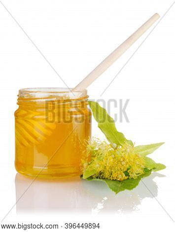 Full Jar With Linden Honey, Honey Dipper And Lime Flowers Isolated On White Background.