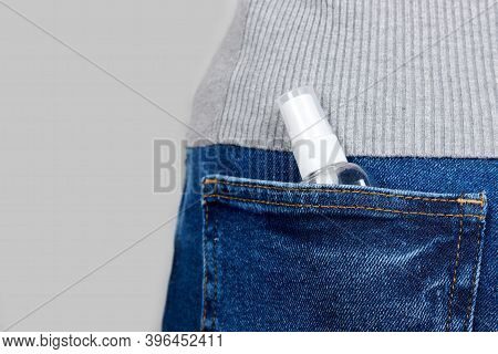 Medicine Anticeptic In Jeans Pocket On Grey Background.