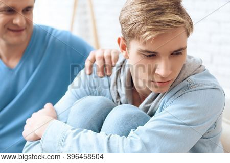 Father Tries To Talk To His Son, But Problem Teenager Doesn't Want To Listen, Looking Away.