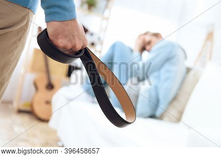 Father Comes To His Son With Belt Ho Hit Him. Troubled Teenager Isn't Defending Himself.