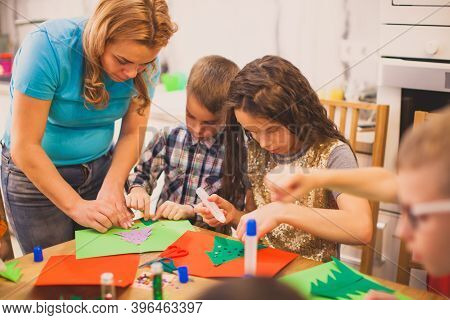 Mother Creates Paper Greeting Cards Together With Her Chldren
