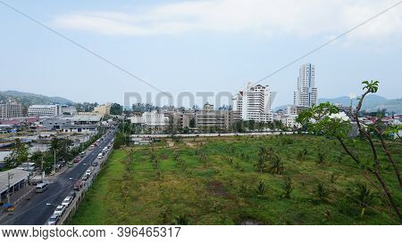 Drone View Of The City Of Patong, Phuket Island. Houses Of Different Heights Stand On The Beach. Gre