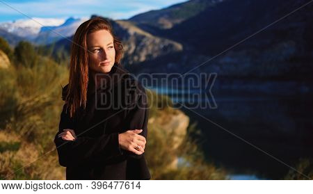 Young Brown Haired Beautiful 25s 30s Woman Posing On Mountainous Background. Concept Of Winter Holid