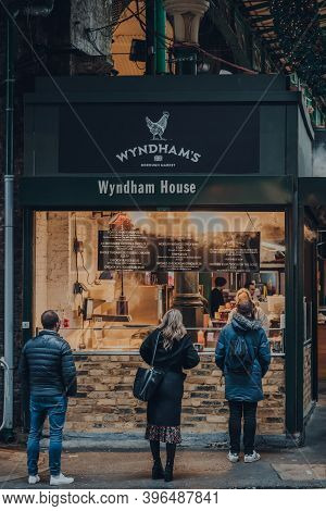 London, Uk - November 19, 2020: People Socially Distanced Queuing At A Wyndham Take Away Food Stall 