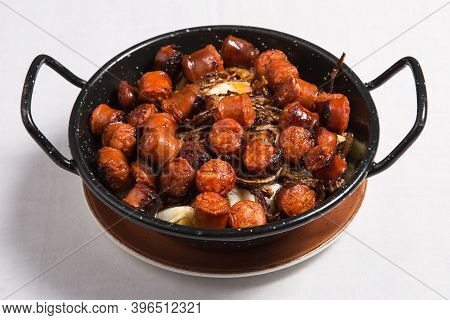 Scrambled Eggs With Sausage And Potatoes Called Huevos Rotos. Spanish Style.