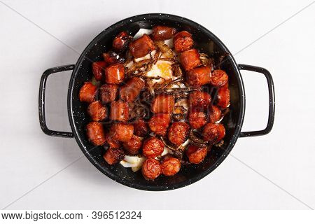 Spanish Food Called Huevos Rotos Con Chistorra. Scrambled Eggs With Sausage And Potatoes. Spanish St