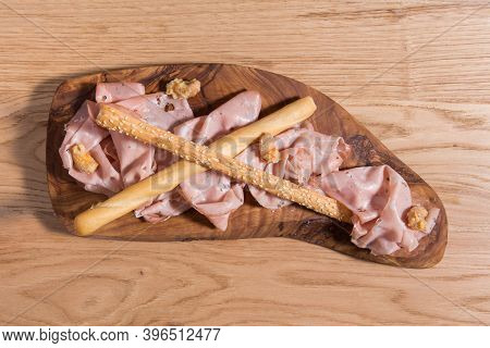 Set Of Mortadela Slices. Italian Salami On A Wooden Background