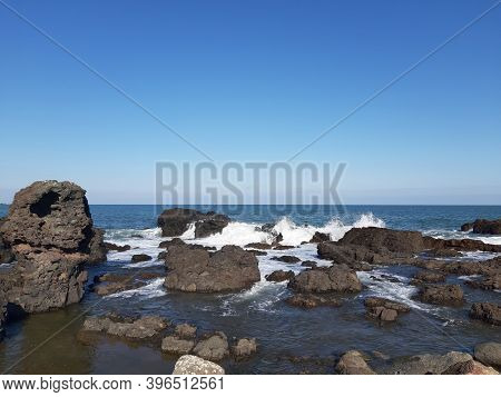 Waves Hitting The Coast Side In Udo Island. Udo Is A Small Island