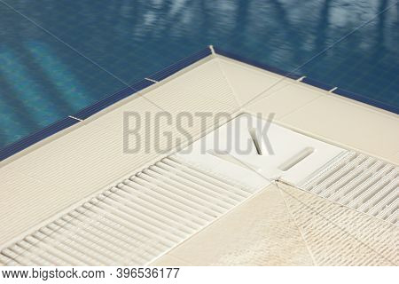 Edge Of Swimming Pool Background. Swimming Pool Edge And Blue Clean Water. Holidays And Spa Concept.
