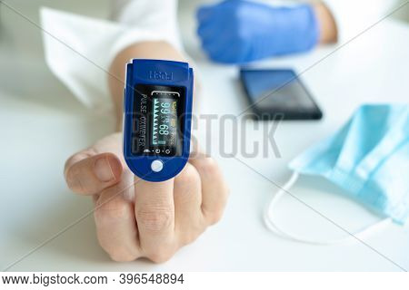 Woman Using Pulse Oximeter To Show By Hand The Symbol Of The Fuck Off. Coronavirus Concept.