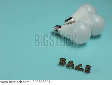 Eco Three Led Light Bulbs On Blue Background.