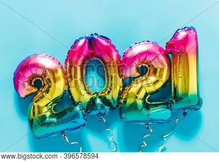 Rainbow Colored Foil Balloons In The Form Of Numbers 2021 On Blue Background