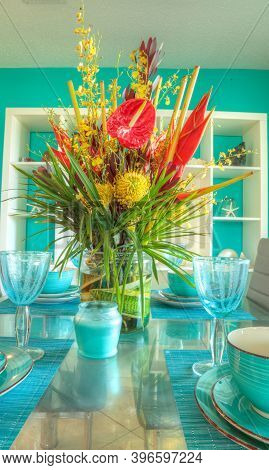 Tropical Blue Table Set With Flowers Including Heliconia Bihai, Yellow Oncidium Orchids