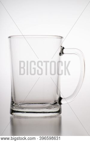 Pouring Water Into A Mug. Glass Container For Weak Carbonated Alcohol.