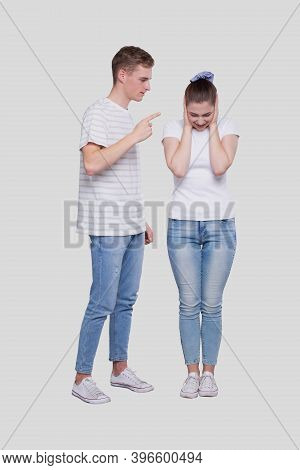 Couple Having A Fight. Man Screaming At Girl. Man Is Not Satisfied. Couple Standing Isolated. Girl C