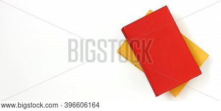 Two Books, Red And Yellow, On A White Background, Top View. Education, Volumes Of Classical Literatu