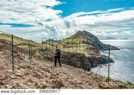 Girl Hiking Rocky Cliffs Clear Near Water Of Atlantic Ocean Bay Ponta De Sao Lourenco, The Island Of