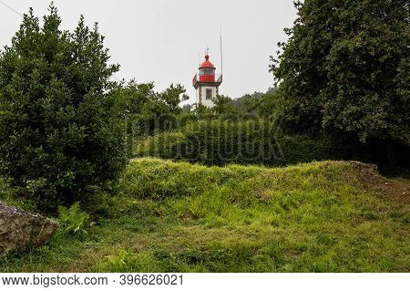 The Lighthouse Of Morgat (brittany, France) On A Cloudy Day In Late Summer