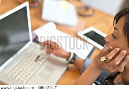 Upper view of businesswoman working on laptop computer