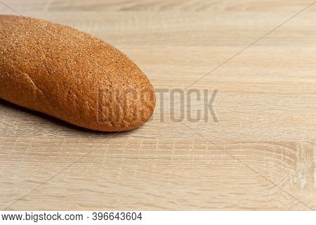 Freshly Baked Traditional Black Bread On A Wooden Table. Brown Coarse Bread Made From Shenitsa, Barl