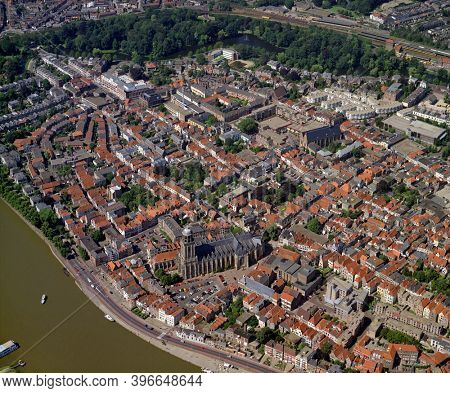 Deventer, Holland, July 11 - 1990: Historical aerial photo of the city Deventer situated on the east bank of the river IJssel and Lebuinuskerk in front in the province Overijssel
