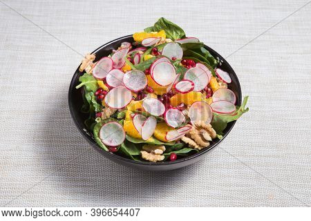 Fresh Salad With Pomegranat, Oranges, Onion, Nuts, Spinach, Radish