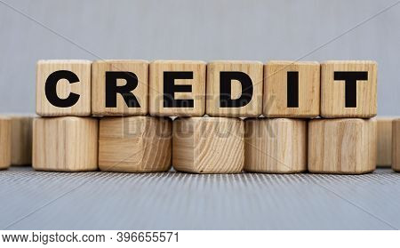 Credit - Word On Wooden Cubes On A Beautiful Gray Background. Business Concept