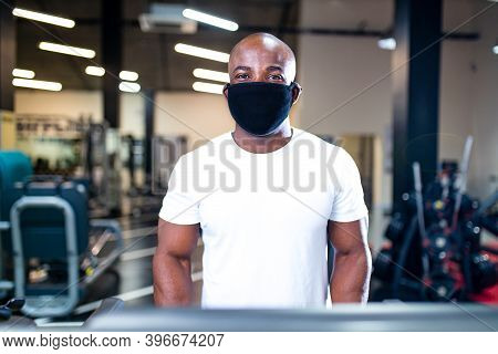 Spain Man In White Cotton T-thirt Wearing Mask While Working Out In Gym