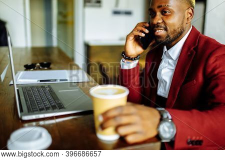 African American Man Getting Online Education And Drinks Coffee To Go Frop Paper Eco Cup