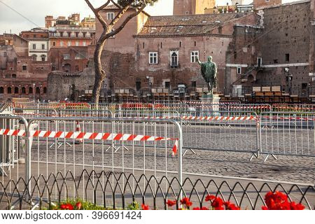 Road barriers with red-and-white warning tape blocking the Via dei Fori Imperiali road at Rome, Italy - lockdown due to Coronavirus COVID-19 pandemic outbreak concept