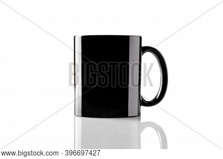 Black Porcelain Mug For Coffee Or Tea On Glossy Surface Isolated On White Studio Background. Mock Up