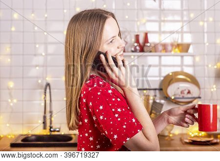 Happy Laughing And Smiling Young Beautiful Woman Talking By Mobile Phone In Kitchen In Red Pygamas H