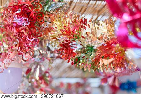 Colorful Festive Decoration Shiny Garland At Sunset Light.