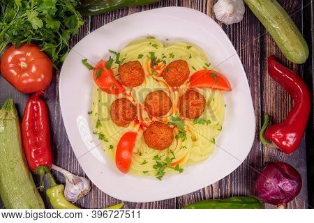 Tasty Meatballs Over Mashed Potatoes, In A Plate On A Wooden Table, Top View