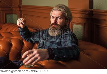 Luxury And Success. Smoke Cigarette While Drink Brandy Or Cognac. Hard Beverage For Real Men. Brutal