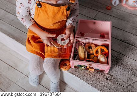 Toy Kitchen Presents For Girls. Christmas Present Under The Tree. Little Girl Playing Toy Wooden Kit