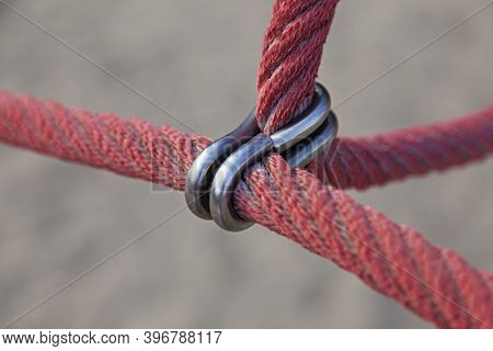 Two Red Thick Ropes Are Attached With Metal Ring