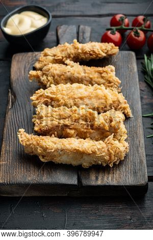 Fried Crispy Chicken Stripes On Old Dark Wooden Table