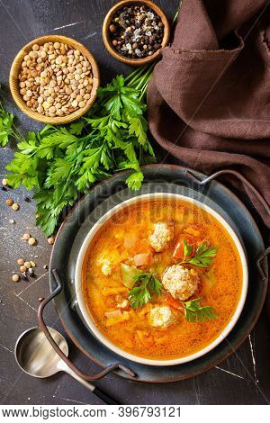 Tomato-lentil Soup With Meatballs And Vegetables On A Dark Slate Table Top. Top View Flat Lay Backgr