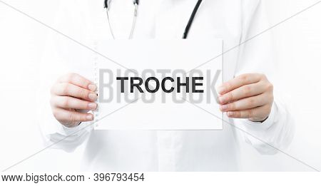 Doctor Holding A Card With Text Troche, Medical Concept
