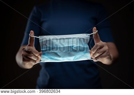 Close Up Shot Of Hands Holding Protective Face Mask.