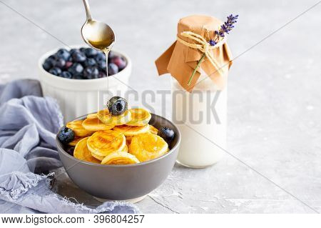 Mini Pancakes In A Bowl With Maple Syrup.
Dutch Mini Pancakes Are Called Strawberry Potato Pancakes.