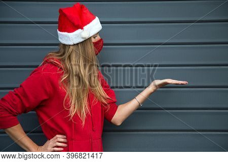 Longhair Blond Caucasian Girl In Red Sport Wear, Christmas Hat And Sparkling Face Protective Mask Pr