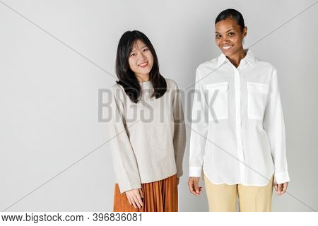 Asian and African woman in minimal style clothing