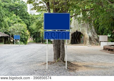 Blue Traffic Sign In Paking Lots With Tree Around. Clipping Paths
