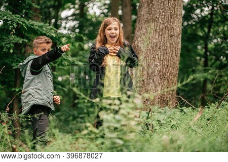 Happy Little Friends Walking And Having Fun In Spring Forest