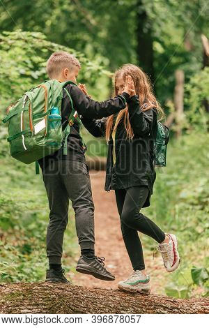 Kids Spending Time In Beautiful Nature And Having Fun, Holding Hands Together.